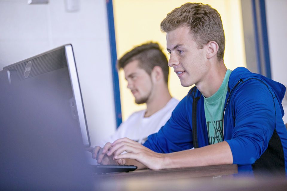 Student interacting with computer utilizing online programs at WVU Potomac State College 
